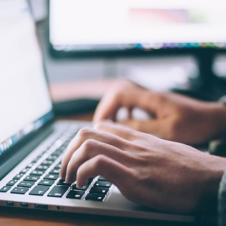 A person typing on a laptop